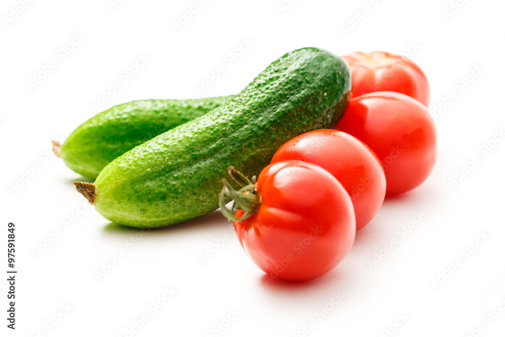 Fresh cucumbers and tomatoes on white Fresh cucumbers and tomatoes on white