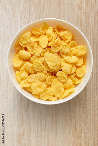 Yellow corn flakes in white bowl on