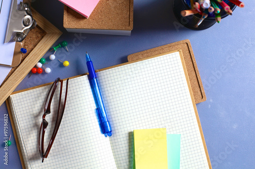 Desk of an artist with lots of stationery objects