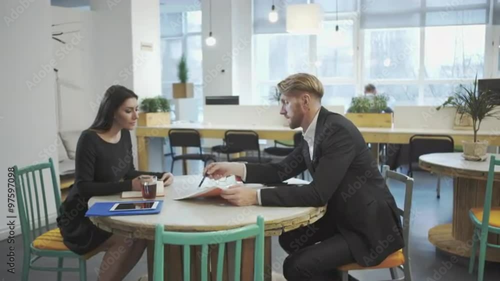 Business Partners at the meeting. Lady discusses strategy with a man. Business Partners at the meeting. Lady discusses strategy with a man.