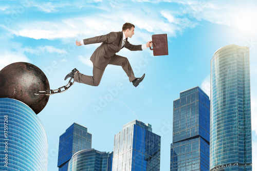 Man with iron ballast hopping over city
