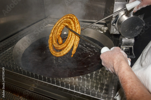 Freír churros. Churrería. Churrero preparando churros, buñuelos y porras. photo