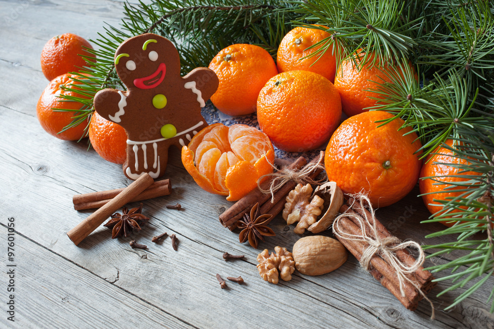 Christmas table with tangerines , gingerbread and fir branches Christmas table with tangerines , gingerbread and fir branches