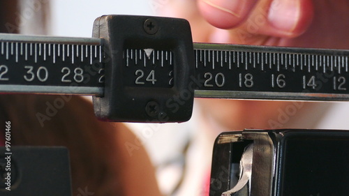 Exam: Doctor Adjusts Scale To Find Patient's Weight