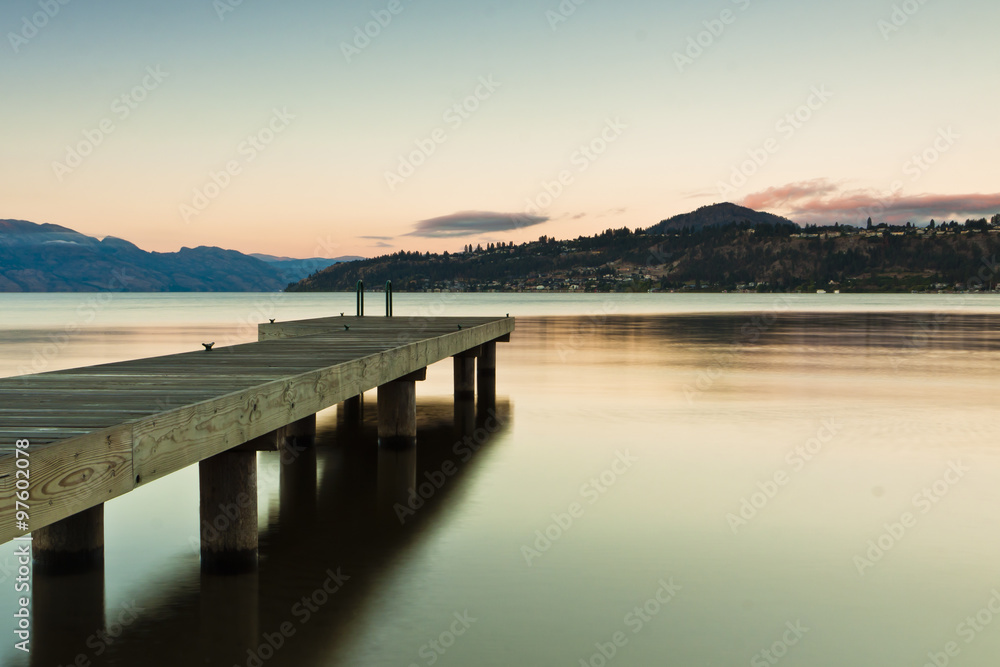 boat dock on mountain lake at sunrise