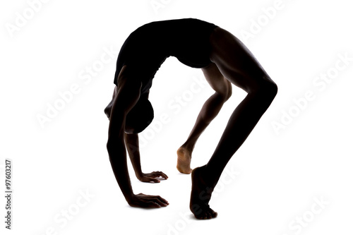 Quadro em tela Silhouette of a flexible male dancer posing and balancing on white background