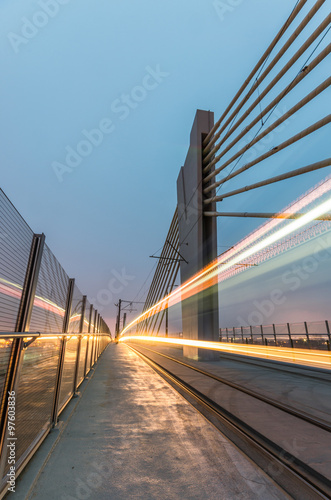 Tram lights trails on tram cable-stayed bridge in Krakow, Poland