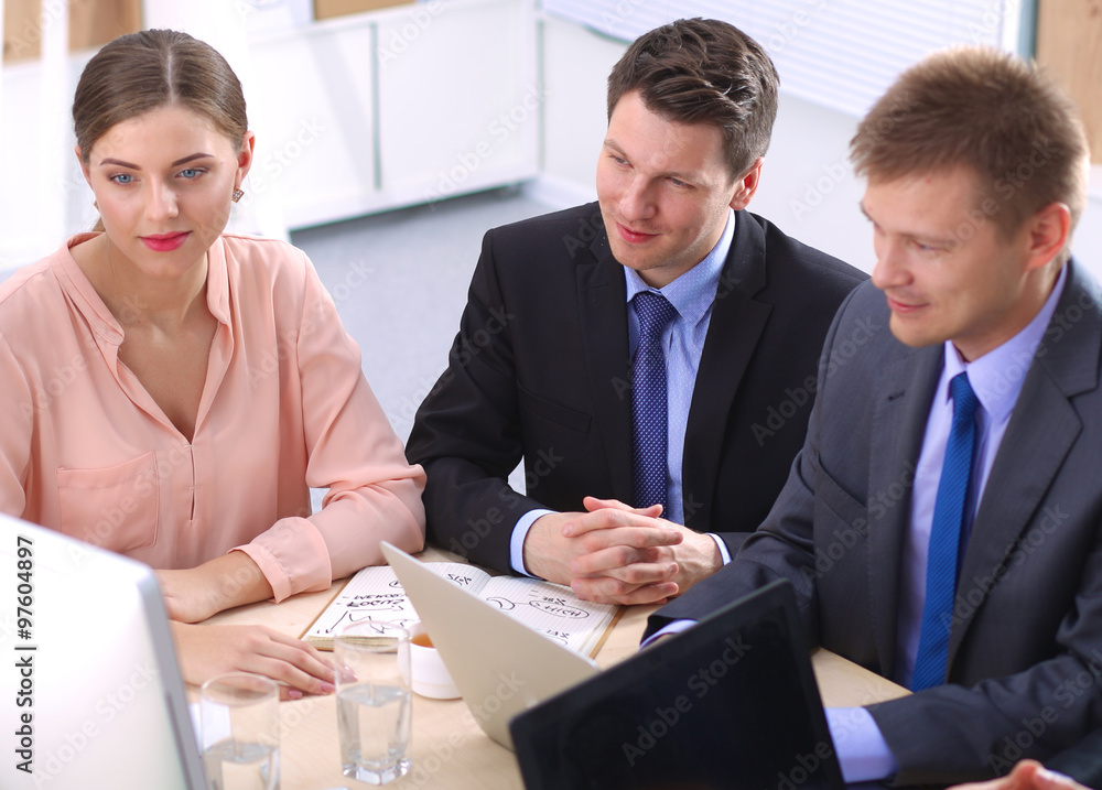 Business meeting - manager discussing work with his colleagues Business meeting - manager discussing work with his colleagues