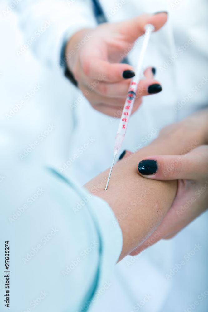 Doctor giving an injection to a patient..toned image. Doctor giving an injection to a patient..toned image.