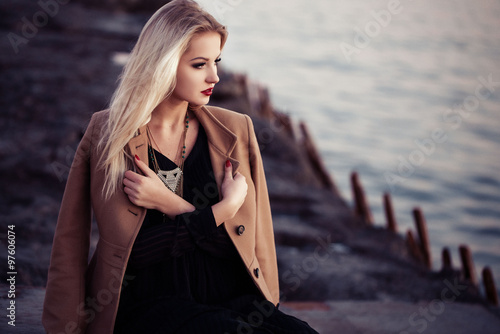 High fashion photo of elegant woman in black long dress and styl