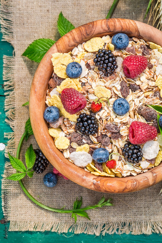 Healthy breakfast with milk and berry fruits in garden