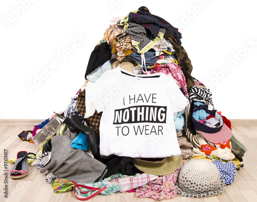 Fotografie Big pile of clothes thrown on the ground with a t-shirt saying nothing to wear