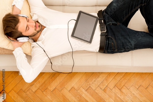 Young man with a Tablet PC on the sofa