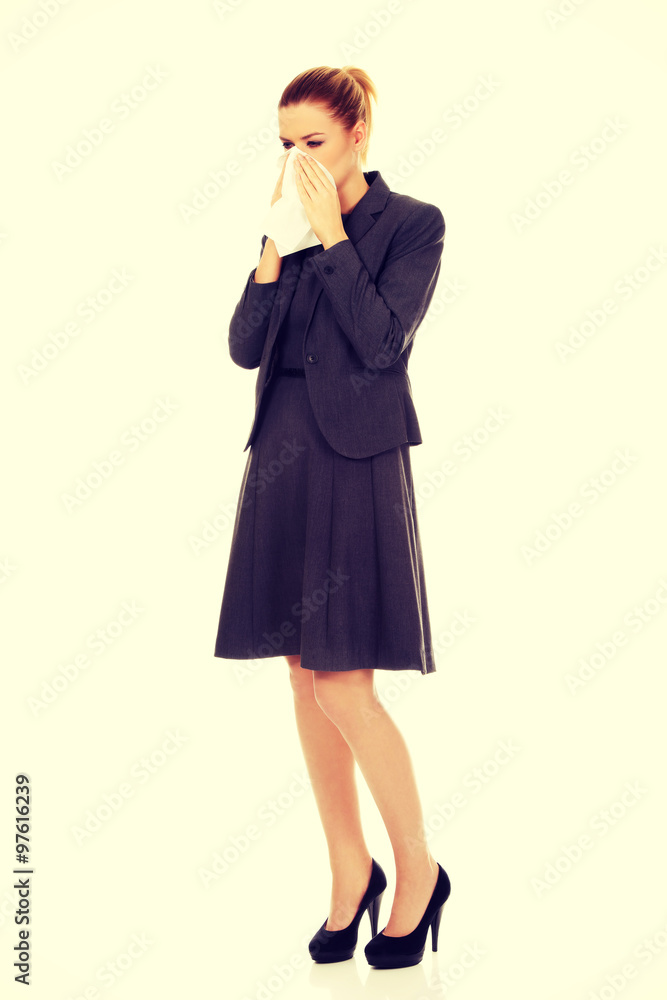 Businesswoman with sneezing into tissue. Businesswoman with sneezing into tissue.
