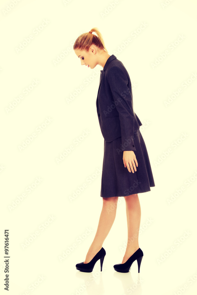 Young business woman looking down. Young business woman looking down.