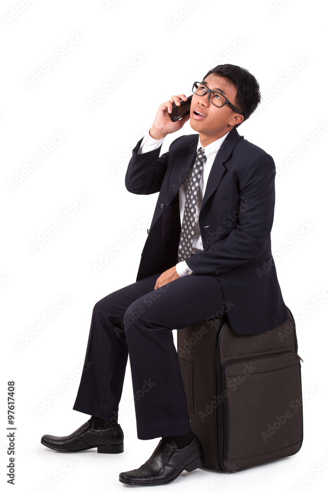 Businessman running with suitcase and using telephone on a white background Businessman running with suitcase and using telephone on a white background