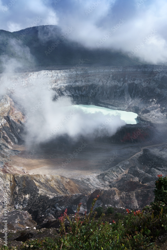 Fototapeta premium Steam erupting from active volcano with mountain range in background, Costa Rica