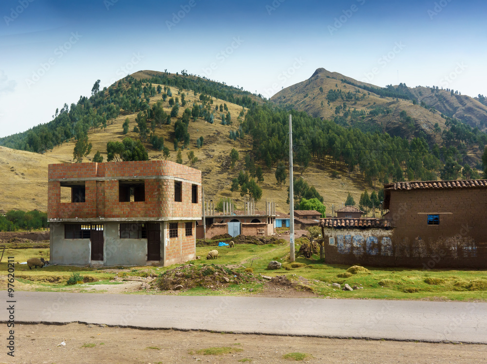 Village on hill with mountain in background, Cusco, Peru