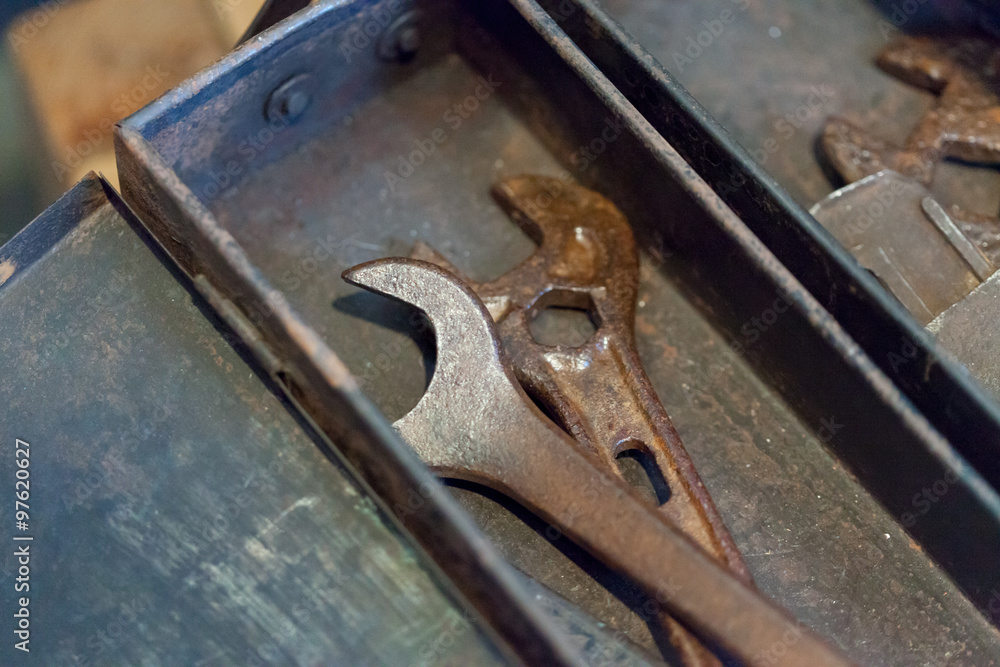Close-up of rustic spanner in box