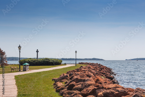 Empty bench and footpath on the coast, Victoria park, Charlottetown, Prince Edward Island, Canada photo