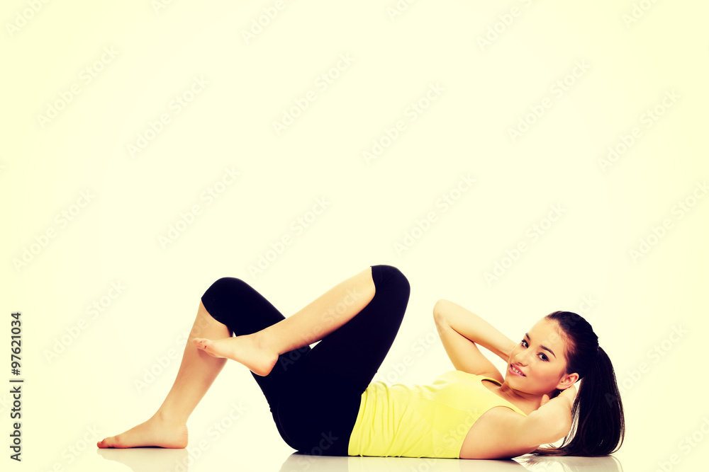 Fototapeta premium Woman exercising and doing a crunch.