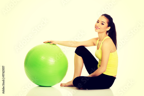 Young woman exercising with pilates ball.