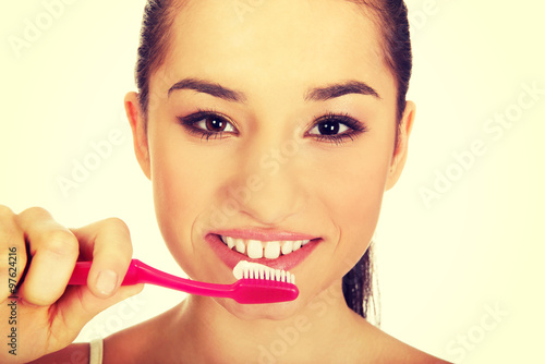 Young woman brushing her teeth.