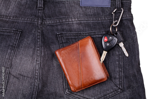 Brown wallet, car keys on black jean.