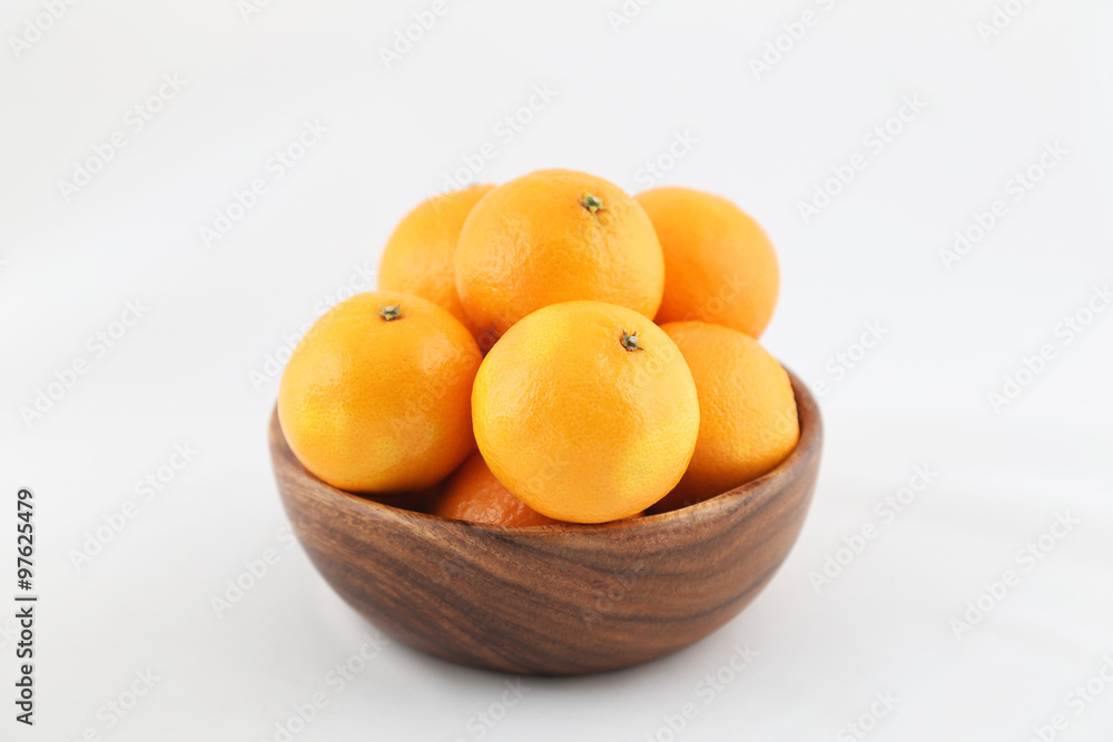 tangerines in a wooden bowl