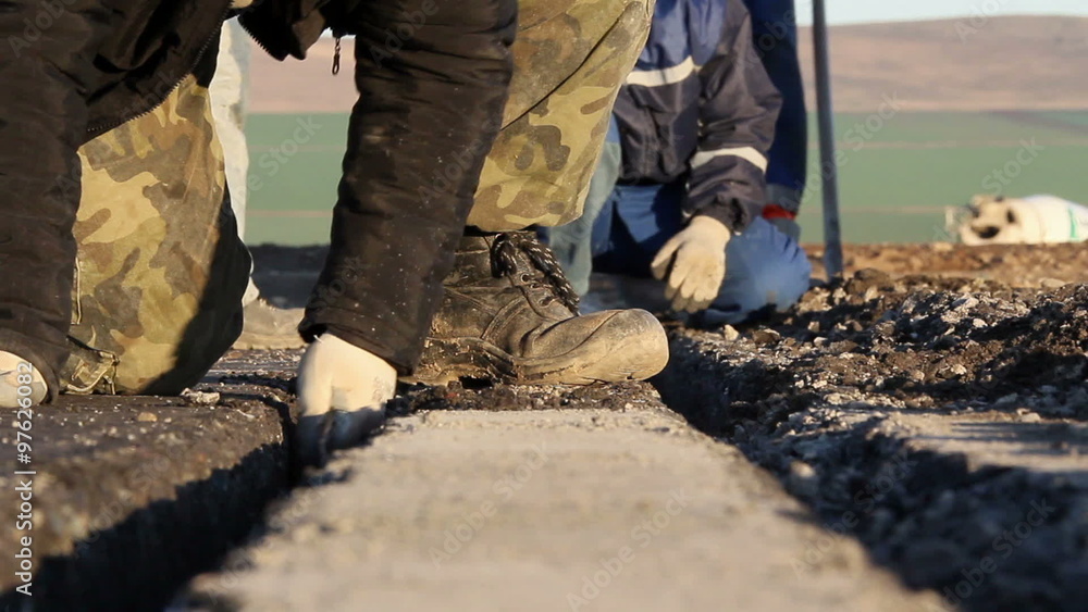 Workers dig trenches to lay cables for the airfield lighting system Workers dig trenches to lay cables for the airfield lighting system
