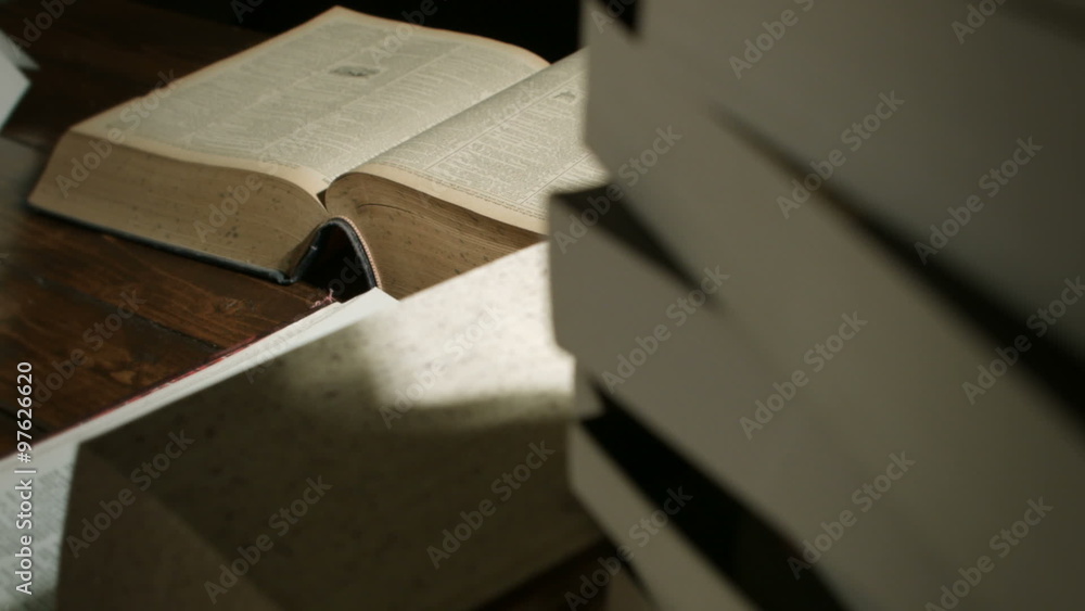 Dolly Motion Studio Shot of Big Books Stacked on a Desk at Night for any Education Concepts Dolly Motion Studio Shot of Big Books Stacked on a Desk at Night for any Education Concepts