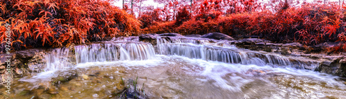 Fototapeta Naklejka Na Ścianę i Meble -  Panoramic view of Beautiful autumn waterfall in deep forest.