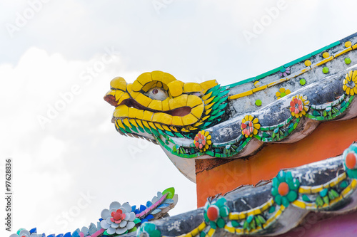 Dragon Head Statue on the corner of the colorful  Roof