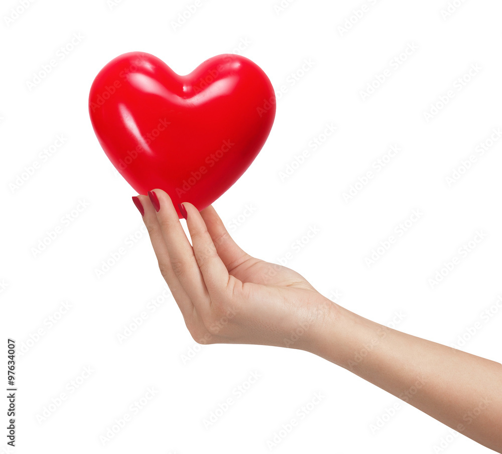 Red heart in woman hand, isolated on white Red heart in woman hand, isolated on white