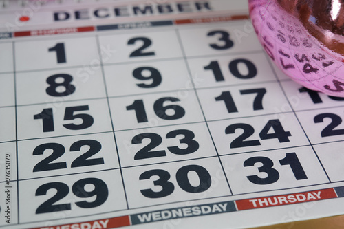 calendar December 2015, the eve of the new 2016 closeup, December 31 Thursday, on the backdrop of pink Christmas balls