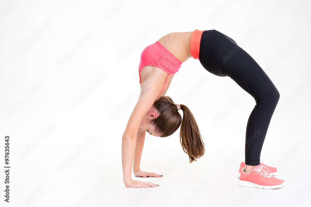 Beautiful young sportswoman doing back bend Beautiful young sportswoman doing back bend