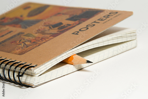 Wallpaper Mural Closed notebook  and pencil on over white Torontodigital.ca