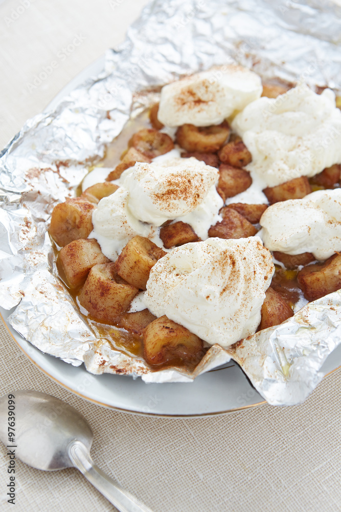 a portion of grilled bananas with whipped cream