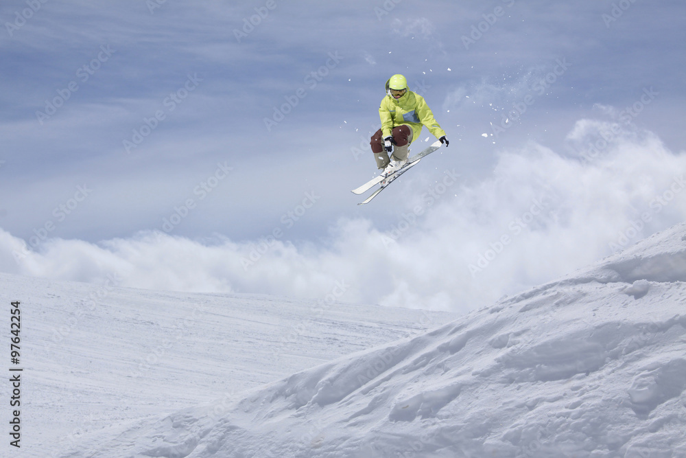 Flying skier on mountains. Extreme sport.