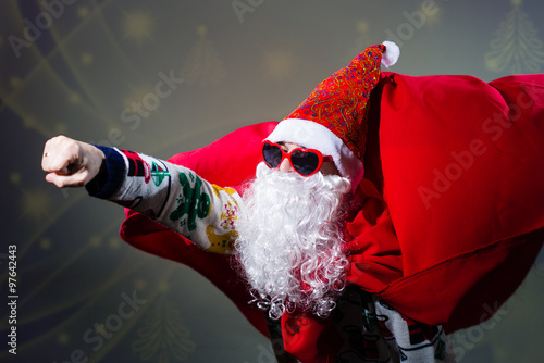 Funky Santa Claus wearing heart shape sunglasses and red shawl  photo