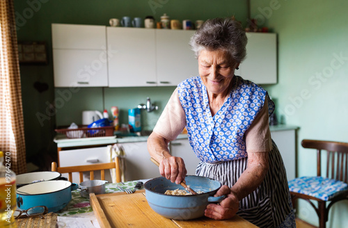 Obraz na plátne Senior woman baking