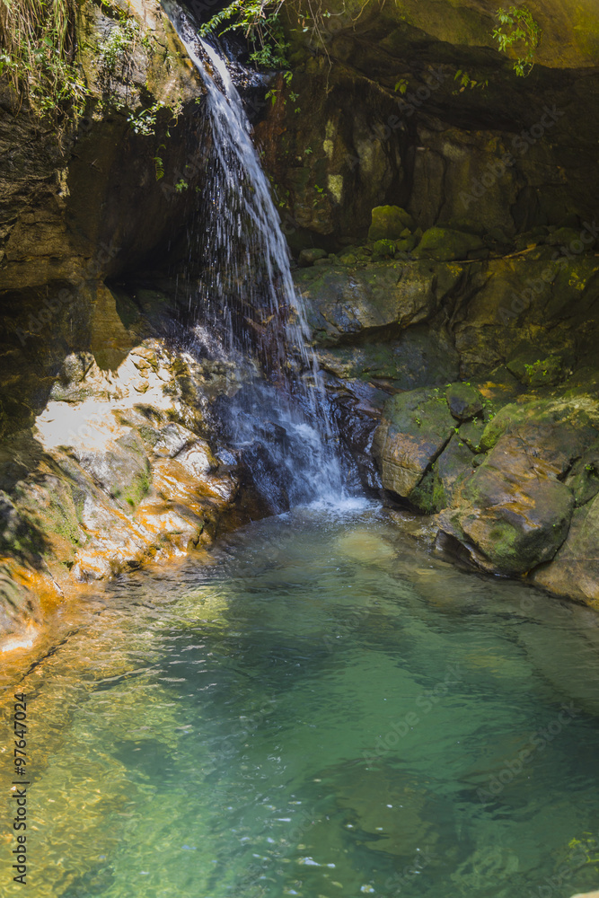 Waterfall on a blue turquoise pond in Isalo, Madagascar Waterfall on a blue turquoise pond in Isalo, Madagascar