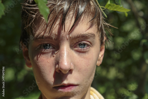 portrait of a teenage boy after swimming in summer