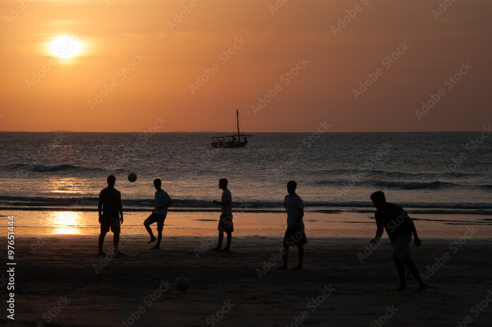 Brazilian guys playing football at Jericoacoara beach, Brazil