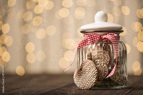 Fototapeta Gingerbread cookies in a jar on a wooden background