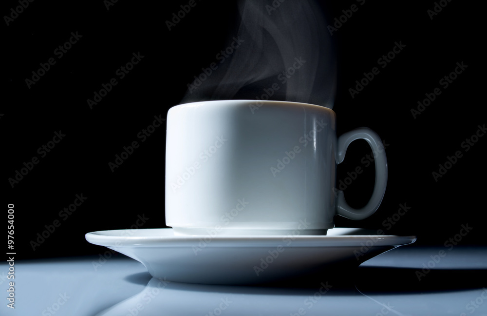 cup of coffee with a beautiful smoke close up on a black background cup of coffee with a beautiful smoke close up on a black background