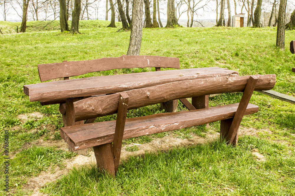 A wooden bench and table outside A wooden bench and table outside