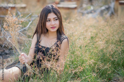 Asian girl in a meadow , light evenings