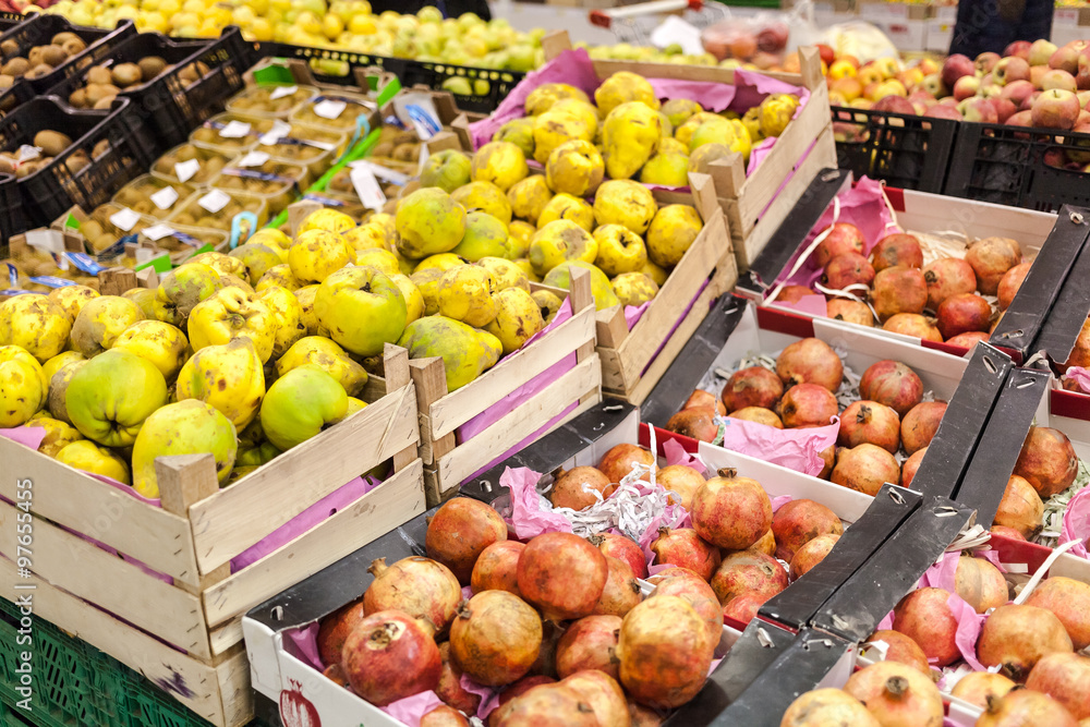 Full shelfs with fruits in supermarket.