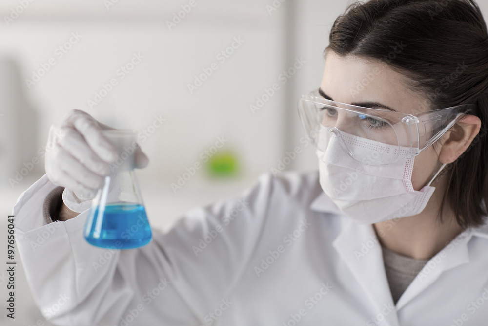 close up of scientist with flask making test close up of scientist with flask making test